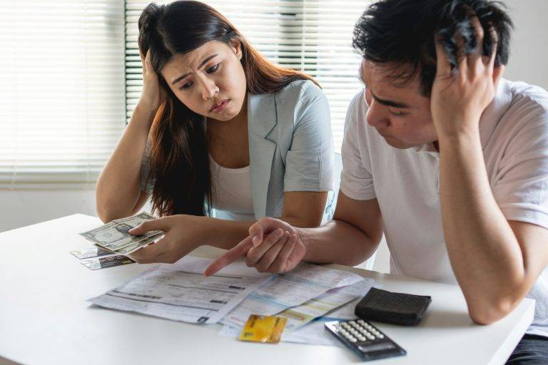 Young Asian couple felling stress, serious about financial problem of credit card debt